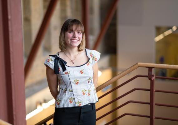 Caroline Robertson standing at the top of Carpenter Library stairs